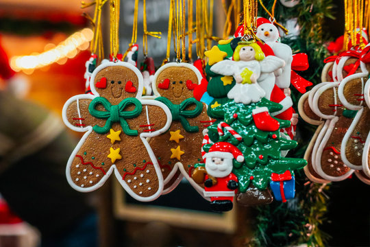 Ginger bread man and handmade Christmas toys on the street market, backdrop. Colorful New Year fair decor sale background.