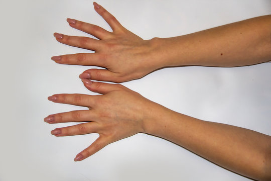A composition of Women's hands which shows a nails light background. Female hands show fiingers. Concept with female hands.