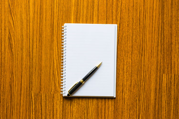 close up opening note paper and pen on wood texture background with copy space