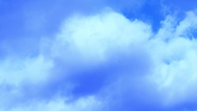 moving gray cloud over blurred blue sky.