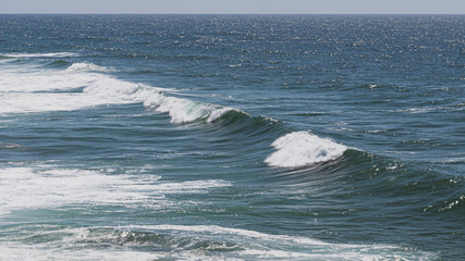 Large ocean waves crashing, on a sunny day. Taken in Portugal.