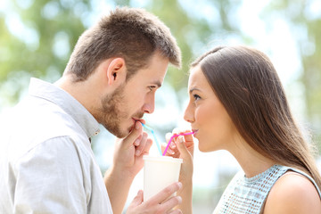 Couple sipping a takeaway drink together