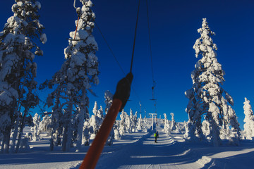 Beautiful vibrant aerial winter mountain view of ski resort, sunny winter day with slope, piste and...
