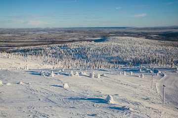 Beautiful vibrant aerial winter mountain view of ski resort, sunny winter day with slope, piste and...