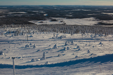 Beautiful vibrant aerial winter mountain view of ski resort, sunny winter day with slope, piste and ski lift