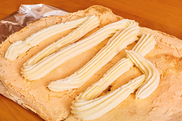 butter cream squeezed out of a pastry syringe lies on the cake