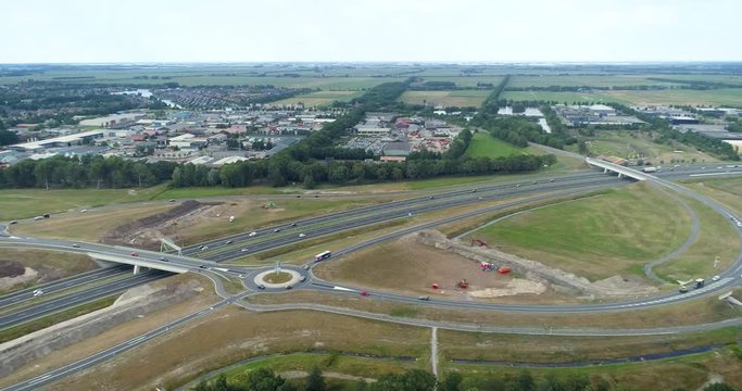 Joure Highway Junction with Roundabouts, Pan Shot Following Fast Driving Cars - Friesland, Netherlands / Holland &ndash; 4K Drone Footage