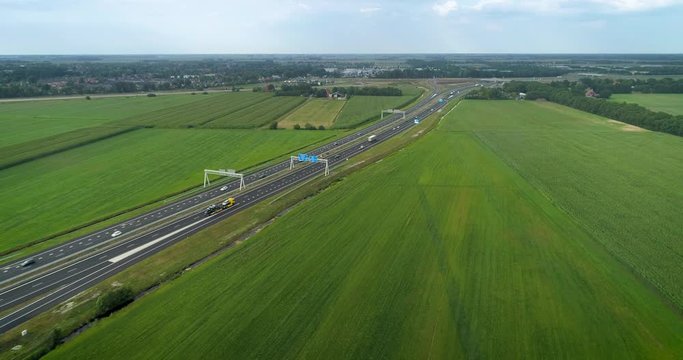 A Yellow Car Carrier Trailer on the A6 Highway, Near Joure and Heerenveen - Friesland, Netherlands / Holland &ndash; 4K Drone Footage