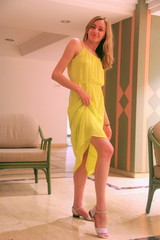 A girl in a hotel in a yellow dress