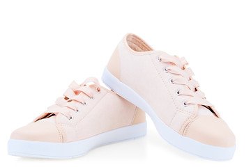women's pink canvas canvas comfortable shoes on a white background sneakers - obrazy, fototapety, plakaty