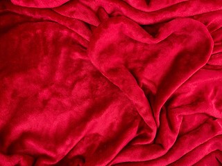 Colorful heart on soft cloth. Heart on a red coverlet. Concept: valentines day, love