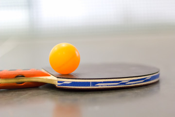 Racket and ball on table tennis table