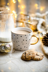 Cozy winter holiday decoration, Christmas lights and coffee cup with decor details, real home