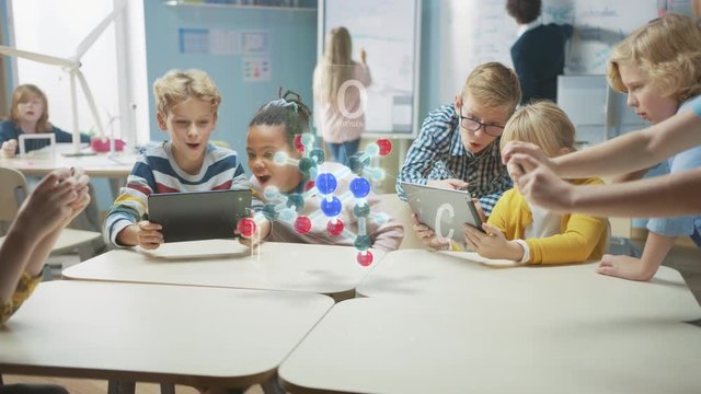 Group of School Children in Chemistry Science Class Use Digital Tablet Computers with Augmented Reality Application, Looking at Educational 3D Animation of a Molecule. VFX, Special Effects Render