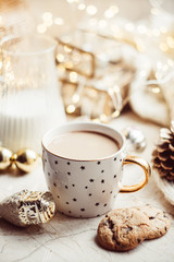 Cozy winter holiday decoration, Christmas lights and coffee cup with decor details, real home