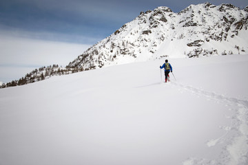 Fototapeta na wymiar winter trekking in a beautiful sunny day. Gran Paradiso National Park, Italy