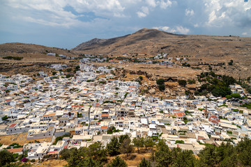 Fototapeta na wymiar View at the city of Lindos on Greek island Rhodes with white houses and mountain in the background