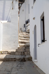 Narrow lane with stairs and white houses in Lindos on Greek island Rhodes
