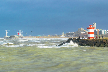 North Sea landscape featuring detail of small harbor skyline with pier and breakwater in Kijkduin, the Netherlands, in stormy day in January. 