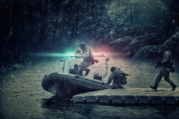 Group of military fighters on a boat with a flasher are chasing pirates. The concept of sea...