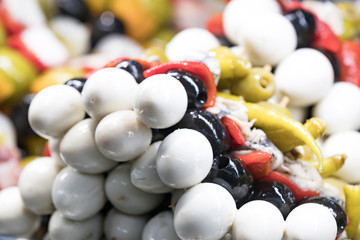 Canapes of seafood cheese vegetables on wooden sticks without GMOs.