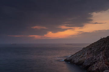 Ships crossing the sea at sunset in the surroundings of Avilés, Asturias, Spain.