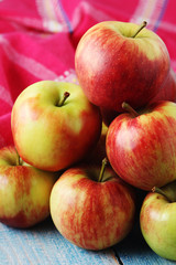 Several ripe red apples on the wooden table
