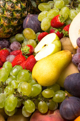 fruits background from fresh juicy fruits apples grapes, pineapple, papaya, pear, peach, figs, strawberries.