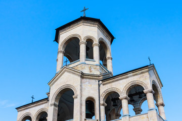 Fototapeta premium View to chapel on site to Sameba Cathedral Tsminda in Tbilisi (Holy Trinity). Biggest church Orthodox in Caucasus Georgia region in a sunny day. The main cathedral of the Georgian Orthodoxy
