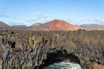Rocky coastline Los Hervideros in the south west of canary island Lanzarote with rough sea, lava caves and multi colored volcanic rocks