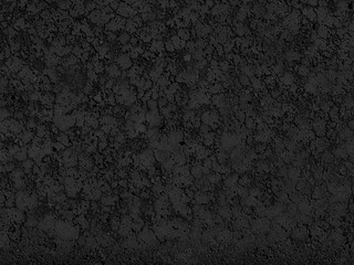 Fototapeta premium Black background cement wall. Monolithic plaster decorative backdrop. Single layer scraped cement plaster wallpaper. Concrete exterior building structure backdrop. Silica sand cement wall plaster