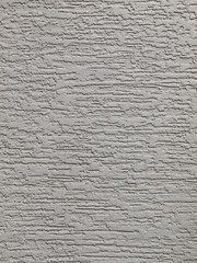 Gray background facade plaster . Monolithic plaster decorative backdrop. Single layer scraped cement plaster wallpaper. Exterior building structure backdrop. Silica sand cement wall plaster