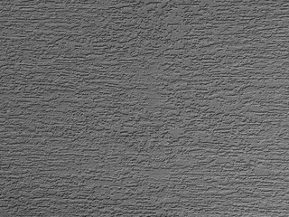 Dark background facade plaster . Monolithic plaster decorative backdrop. Single layer scraped cement plaster wallpaper. Exterior building structure backdrop. Silica sand cement wall plaster