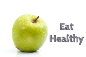 Eat Healthy words written on isolated background with fresh green apple