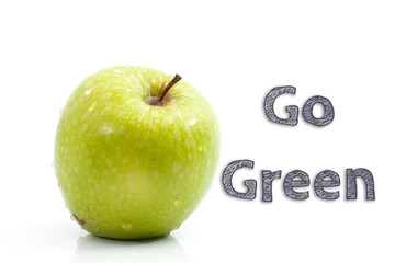 Go Green words written on isolated background with fresh green apple