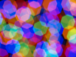 Abstract color pattern inside of kaleidoscope. Little pieces of light are mixed in one geometric ornament. Colorful vivid background. Seamless multicolored tile backdrop.