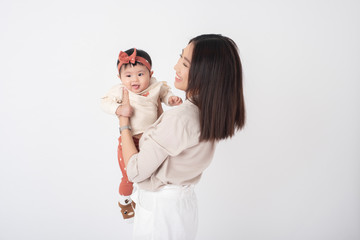 Asian mother and adorable baby girl are  happy on white background