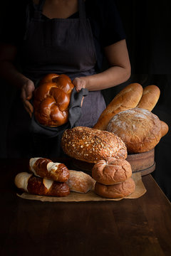 Baker holding bread 