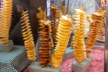 Tornado twisted fried potato chips on the counter on the festival fair