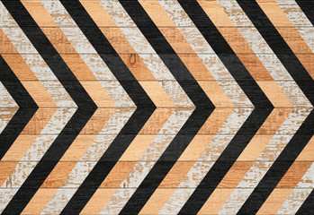 Vintage wooden wall made of planks painted in white, black, and brown. Multicolored wooden floor with geometric pattern. 