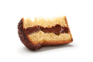 A slice of panettone, an Italian type of sweet bread loaf, with icing, filling and chocolate sprinkles on top, usually prepared and enjoyed for Christmas and New Year. Isolated on white background.