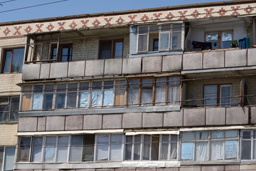 Fototapeta na wymiar Row of windows at an old soviet style appartment building