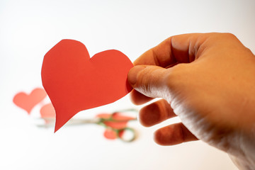 Creating love by cutting the heart out of paper.