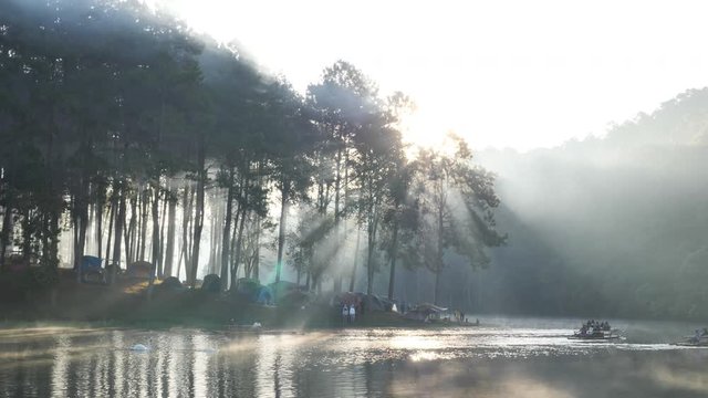 Morning atmosphere sunlight Bamboo rafting tourist over the lake Pang Ung Forestry Plantations, Maehongson Province, North of Thailand Asia. Tourist attractions relax with nature. Slow Motion