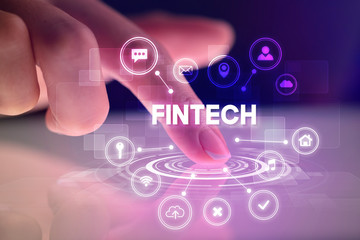 Finger touching tablet with web technology icons and FINTECH inscription, web technology concept