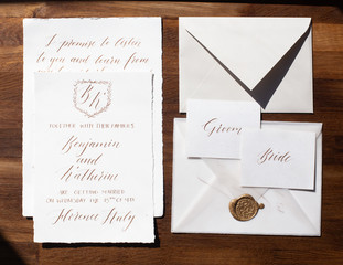Wedding details flat lay on wooden background. Wedding invitation. Wedding bouquet. Mock up. Envelope. Copy space.