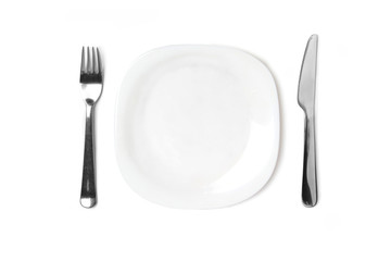 Empty white plate on a white isolated background, next to the plate are cutlery.