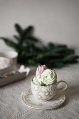 Fototapeta na wymiar green, pink, marshmallows in a cup, herringbone-shaped cake