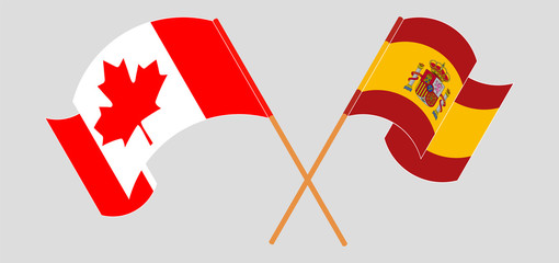 Crossed and waving flags of Canada and Spain