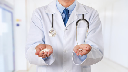  doctor hands holding sugar and saccharin pills